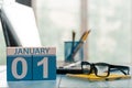January 1st. Day 1 of month, calendar on teacher workplace background. Winter time. Empty space for text Royalty Free Stock Photo