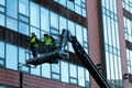 January 29th, 2018, Cork, Ireland - men doing high-rise window cleaning work in the Blackpool Retail Park