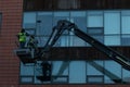 January 29th, 2018, Cork, Ireland - men doing high-rise window cleaning work in the Blackpool Retail Park