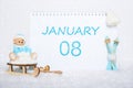 January 8th. Teddy bear sitting on a sled, blue skis and a calendar date on white snow. Day 8 of month. Royalty Free Stock Photo