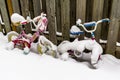 Toy bikes covered in snow in the backyard