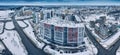 Drone aerial view of a residential highrise building in modern city district with busy road and
