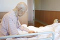 Jaoanese elderly man patient sitting on bed Royalty Free Stock Photo