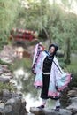 Japan anime cosplay portrait of girl with comic costume with japanese theme garden