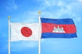 Japan and Cambodia two flags on flagpoles and blue cloudy sky