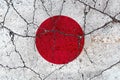 Japan flag on cracked concrete surface after earthquake