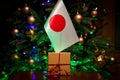 Japan flag and gift box on the background of the Christmas tree