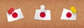 Japan flag pinned in cork board, three versions of Japan flag