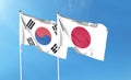 Japan flag and South Korea flag on cloudy sky. waving in the sky Royalty Free Stock Photo