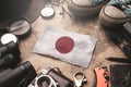 Japan Flag Between Traveler`s Accessories on Old Vintage Map. Tourist Destination Concept Royalty Free Stock Photo