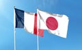 Japan and France flags against cloudy sky. waving in the sky Royalty Free Stock Photo