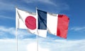 Japan and France flags against cloudy sky. waving in the sky Royalty Free Stock Photo