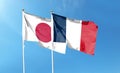 Japan and France flags against cloudy sky. waving in the sky Royalty Free Stock Photo