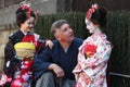 A man and two children in national Japanese clothes at Gion district