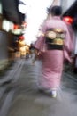 Japan Kyoto Pontocho-dori Woman wearing kimono walking on narrow street motion blur Royalty Free Stock Photo