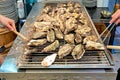 Japan. Miyajima. Hiroshima. Grilling oysters in a restaurant