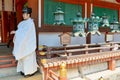 Japan. Nara. Buddhist monk outside the Honden temple, national treasure