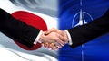 Japan and NATO handshake, international friendship relations, flag background