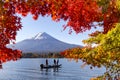 Fuji Mountain and Fisherman Boat in the Frame of Red Maple Leaves in Autumn, Kawaguchiko Lake, Japan Royalty Free Stock Photo