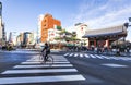 Tourist ride bicycle across zebra crossing in front of Kaninarimon Gate with Crowded of Tourist taking photo at Sensoji Temple,