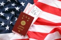 Japan passport with airline tickets on American US flag close up. Tourism and travel Royalty Free Stock Photo