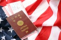 Japan passport with airline tickets on American US flag close up. Tourism and travel Royalty Free Stock Photo