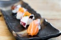 Japan raw salmon sushi and fresh mix sushi set in black plate - Royalty Free Stock Photo