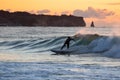 Japan Surf, a man surf many waves on many Surf boards during sunrise and sunset in a blue ocean. Surfing In Japan Royalty Free Stock Photo