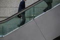 Japan Tokyo Tokyo International Forum two men ascending escalator mid section