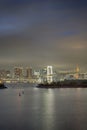 Japan Travel Destinations. Closeup View of Rainbow Bridge in Odaiba Island in Tokyo At Twilight with Line of Skyscrapers Royalty Free Stock Photo