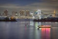 Japan Travel Destinations. Closeup View of Rainbow Bridge in Odaiba Island in Tokyo At Twilight with Tourist Boat and Line of Royalty Free Stock Photo