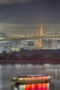 Japan Travel Destinations. Closeup View of Rainbow Bridge in Odaiba Island in Tokyo At Twilight with Tourist Boat and Line of Royalty Free Stock Photo