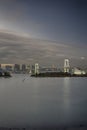 Japan Travel Destinations. View of Rainbow Bridge in Odaiba Island in Tokyo At Twilight with Line of Skyscrapers Royalty Free Stock Photo