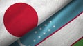 Japan and Uzbekistan two flags textile cloth, fabric texture