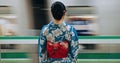 Japan woman, travel and train station in kimono and public transportation on metro bullet in city. Person, motion blur Royalty Free Stock Photo