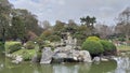 Japaneese garden rock island with mini waterfall Royalty Free Stock Photo