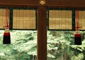 Japanese architectural decorative items hanging along with wooden works background