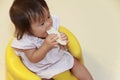 Japanese baby girl eating rice cracker Royalty Free Stock Photo