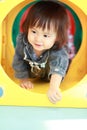 Japanese baby girl passing through a tunnel Royalty Free Stock Photo