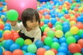 Japanese baby girl playing in ball pool Royalty Free Stock Photo