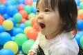 Japanese baby girl playing in ball pool Royalty Free Stock Photo