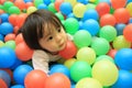 Japanese baby girl playing in ball pool Royalty Free Stock Photo