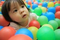 Japanese baby girl playing in ball pool Royalty Free Stock Photo