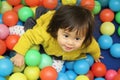 Japanese baby girl playing in ball pool Royalty Free Stock Photo