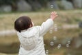 Japanese baby girl playing with bubble Royalty Free Stock Photo