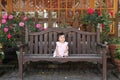 Japanese baby girl sitting on the bench Royalty Free Stock Photo