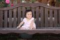 Japanese baby girl sitting on the bench Royalty Free Stock Photo