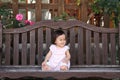 Japanese baby girl sitting on the bench Royalty Free Stock Photo