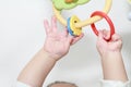 Japanese baby girl stretching her hands to the toy Royalty Free Stock Photo