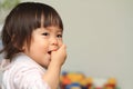 Japanese baby girl sucking her finger Royalty Free Stock Photo